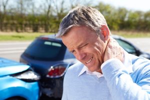 guy holding neck after auto accident