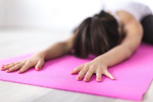 Woman Exercising On A Yoga Mat