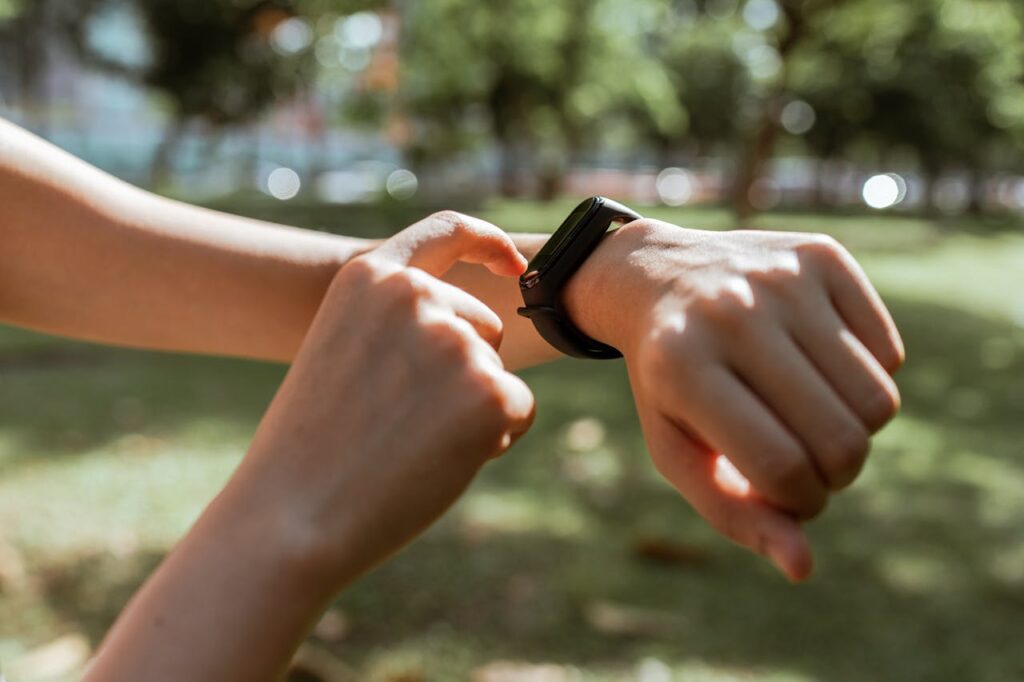Person wearing and interacting with their fitness tracker
