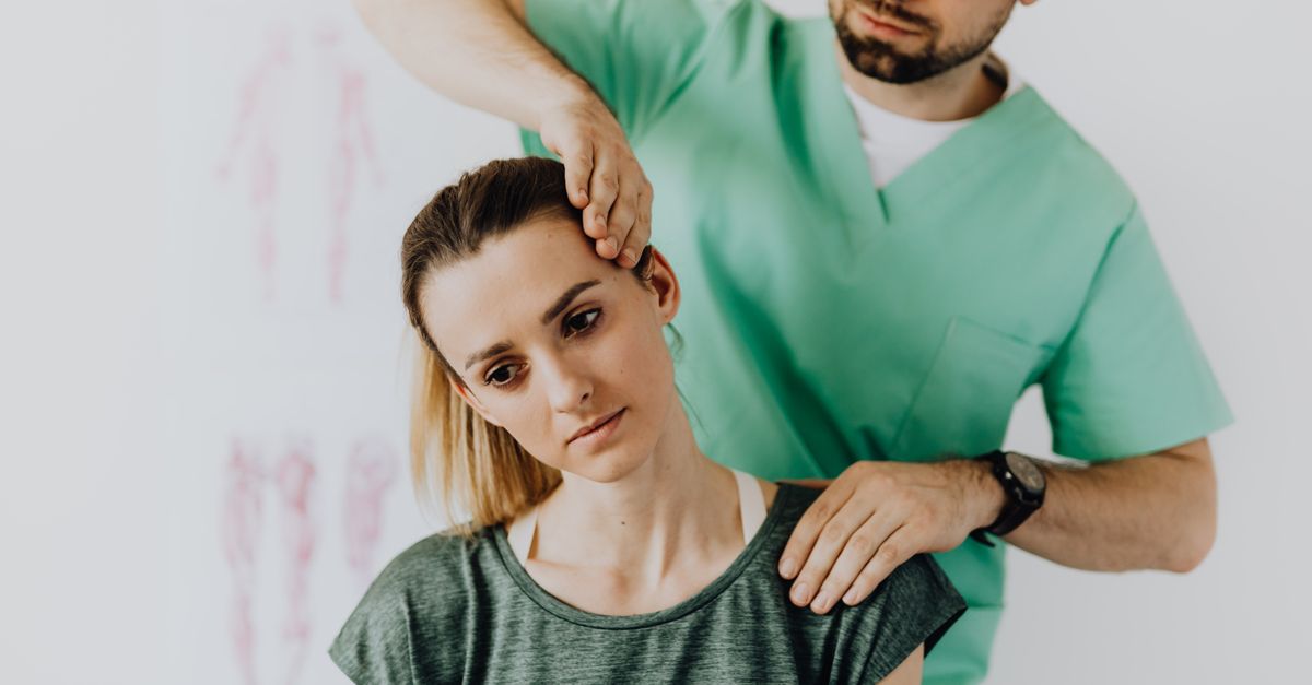 Chiropractor examining a patient's neck to assess neck pain